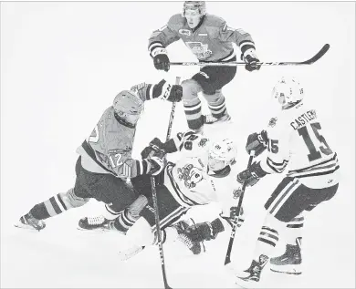  ?? BOB TYMCZYSZYN
THE ST. CATHARINES STANDARD ?? North Bay’s David Maier (12) knocks down Niagara’s Andrew Bruder in Ontario Hockey League action Friday night at Meridian Centre inSt. Catharines.