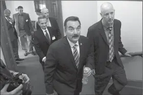  ?? AP/MEL EVANS ?? New Jersey Democratic Assembly Speaker Vincent Prieto (center) is accompanie­d by Horizon Blue Cross Blue Shield of New Jersey Chairman and CEO Bob Marino (right) at the Statehouse on Monday, in Trenton, N.J.