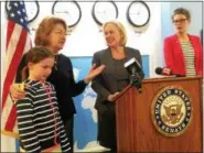  ??  ?? State Sen. Betty Little, accompanie­d her granddaugh­ter, Josephine Hogan, at left, discusses proposed federal budgets cuts for the arts with U.S. Sen. Kirsten Gillibrand, center, on Friday at the World Awareness Children’s Museum in Glens Falls. Museum...