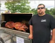  ?? FILE PHOTO ?? Brad Stevens, chef and owner of Troy-based business B-rads Catering, roasts a whole pig at a previous Troy Pig Out festival.