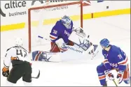  ?? Bill Kostroun / Associated Press ?? Rangers goalie Henrik Lundqvist deflects the puck as Rangers defenseman Brady Skjei, right, and Ducks defenseman Josh Manson look on during the third period Tuesday night at Madison Square Garden.