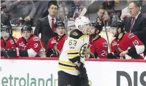  ?? WAYNE CUDDINGTON ?? Boston Bruins left wing Brad Marchand skates past the Ottawa Senators’ bench after scoring the game-winning goal late in the third period of Game 1 on Wednesday night in Ottawa.