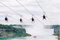  ?? KIEN TRAN/WILDPLAY LTD. ?? In July, tourists suspended above the water from zip lines make their way at speeds of up to 40 mph toward the mist of the Horseshoe Falls on the Ontario side of Niagara Falls.