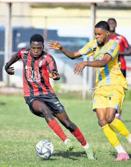  ?? RICARDO MAKYN/CHIEF PHOTO EDITOR ?? Kaheim Dixon (left) of Arnett Gardens moves away from Waterhouse’s Leonardo Jebbison during yesterday’s Jamaica Premier League match at the Drewsland Mini-Stadium. The game ended in a 0-0 draw.