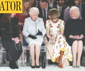  ?? YUI MOKYUI MOK / AFP / GETTY IMAGES FILES ?? Queen Elizabeth at London Fashion Week in 2018 with Angela Kelly, the monarch’s official dressmaker and friend at far right. In her new book, Kelly says she breaks in the monarch’s new shoes.