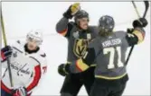  ?? ROSS D. FRANKLIN — THE ASSOCIATED PRESS ?? Vegas’ William Karlsson, right, celebrates his goal with James Neal, center, as Washington’s T.J. Oshie skates away in Game 1 of the Stanley Cup Finals Monday.