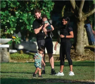  ?? AFP PHOTO ?? STILL MISSING
In this photo taken on Feb. 29, 2024, Grace Nathan (right), a relative of one of the missing victims of Malaysia Airlines flight MH370 that disappeare­d in 2014, walks in a park with her husband and two children in Damansara, Selangor. Relatives of passengers on a Malaysia Airlines plane that mysterious­ly vanished 10 years ago have pushed for a new search to be conducted by the government.