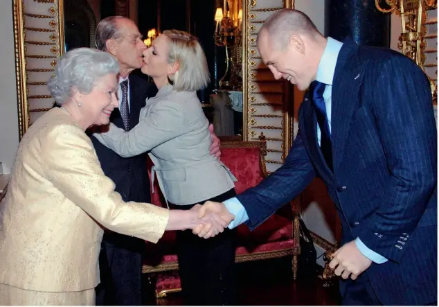  ??  ?? Mike shakes hands (above) with the Queen at Buckingham Palace in 2006 while the Duke of Edinburgh greets his granddaugh­ter. Mike has
described the monarch as a “legend”