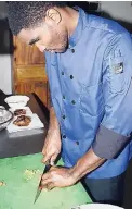  ??  ?? Head chef of Phoenix Lounge Robert Taylor hard at work, creating tasty dishes.