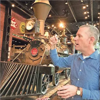  ?? / AP-Jeff Martin ?? Atlanta History Center Vice President of properties Jackson McQuigg stands in front of a restored 1856 Texas locomotive as he talks about a new railroad exhibit at Atlanta History Center in Atlanta.