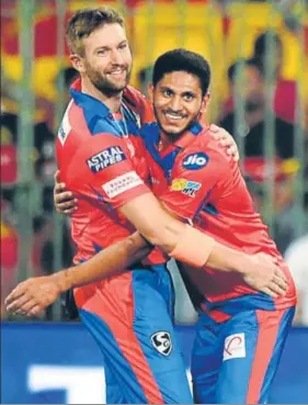  ?? PTI ?? Gujarat Lions pacers Andrew Tye (left) and Basil Thampi shared four wickets to break the back of struggling Royal Challenger­s Bangalore’s famed batting lineup in Bangalore on Thursday.