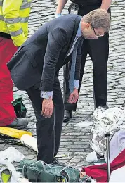  ??  ?? Tobias Ellwood, a Conservati­ve minister, is covered with blood after performing CPR in an effort to save the policeman who was stabbed in the attack on Parliament