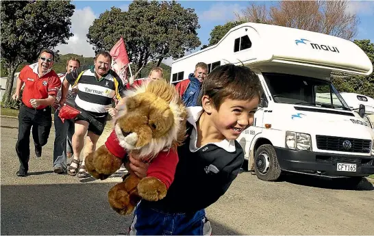  ?? PHOTO: ROSS GIBLIN/FAIRFAX NZ ?? Chandler Hayward, then 5, runs off with the cherished mascot of a group of Lions rugby supporters at the Hutt Park Motor Camp where he stayed during the 2005 tour.