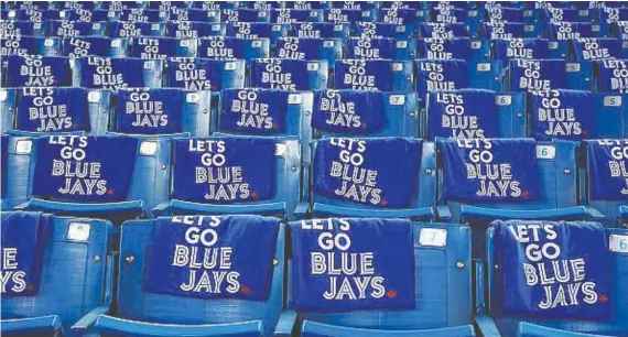  ?? TOM SZCZERBOWS­KI/GETTY IMAGES ?? Towels are placed on seats before the Toronto Blue Jays’ Opening Day game in 2018 against the New York Yankees at Rogers Centre in Toronto.