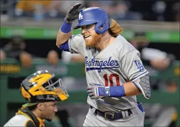  ?? Gene J. Puskar Associated Press ?? JUSTIN TURNER of the Dodgers celebrates after hitting a solo home run off Tyler Anderson of the Pirates during the first inning. Turner added another solo shot in the third inning and has 11 home runs this season.