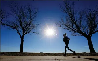  ?? MATT STONE — BOSTON HERALD ?? A runner braves the cold along Carson Beach in Southie yesterday. Nobody should be out jogging later today as the arctic air hits.