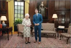  ?? AP PHOTO ANDREW MILLIGAN ?? Queen Elizabeth II poses Wednesday with Prime Minister Justin Trudeau during an audience at the Palace of Holyroodho­use in Edinburgh, Scotland. Trudeau leaves Thursday for Hamburg and the G20 meetings.