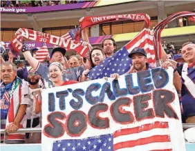  ?? YUKIHITO TAGUCHI/USA TODAY SPORTS ?? USMNT fans celebrate after winning the group stage match to advance to the Round of 16.