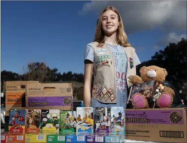  ?? PHOTO BY JOSIE LEPE ?? Amalea Thijssen, 13, sells Girl Scout Cookies at a booth in front of a Starbucks in Palo Alto on Feb. 10. She also sells online.