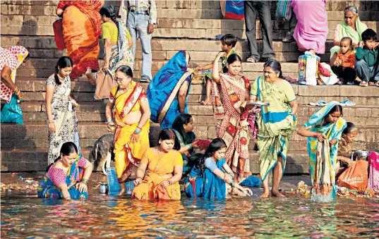  ?? ?? ‘It was an amazing spectacle that lasted all day’: Rhodes, below left, will never forget watching Indian women bathe in the Ganges