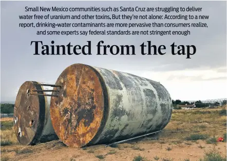  ??  ?? Two rusting water tanks, which date to the 1950s, sit at the edge of the well site in Santa Cruz, a community of 450 residents in northern Santa Fe County. The tanks are being replaced and work is underway on a new water system, but the community still...