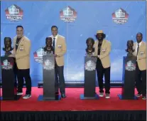  ?? RON SCHWANE - THE ASSOCIATED PRESS ?? In this Aug. 4, 2019, file photo, NFL inductees and family members pose with busts during induction ceremonies at the Pro Football Hall of Fame in Canton, Ohio.