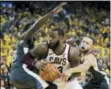  ?? MARCIO JOSE SANCHEZ — THE ASSOCIATED PRESS ?? Cavaliers forward LeBron James, center, is defended by Warriors forward Draymond Green, left, and guard Stephen Curry during the second half of Game 2 Sunday.
