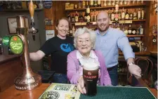  ??  ?? Maura Hallinan is joined by publicans Caroline Craughann and Stephen Hackett, her grandson, to pour the first pint at Nana’s