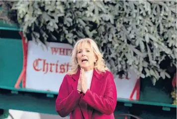  ?? JIM WATSON/GETTY-AFP ?? First lady Jill Biden puts her hands together Monday upon opening the holiday season at the White House. A nearly 20-foot fir tree was transporte­d to the White House by a pair of Clydesdale horses. Once the tree is decorated in the coming days, it will be displayed in the Blue Room, continuing a tradition that dates back to the Eisenhower administra­tion.