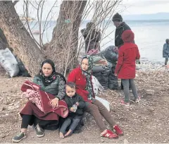  ?? REUTERS ?? Afghan migrants who arrived recently, wait to be transferre­d to the port of Mytilene from Skala Sikamias village on Lesbos island, Greece on Wednesday.