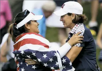  ?? Charlie Riedel/Associated Press photos ?? Lizette Salas, left, celebrates with U.S. team captain Juli Inkster after clinching the winning half point in her singles match against Europe’s Jodi Ewart Shadoff of England.