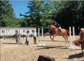  ?? NEWS-HERALD FILE ?? A rider practices a jump at the 2018 Chagrin Hunter Jumper Classic at the Cleveland Metroparks Polo Field in Moreland Hills.