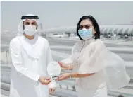  ??  ?? Hjayceelyn Quintana (right), ambassador of the Republic of the Philippine­s to the UAE, presents the Plaque of Appreciati­on to Adnan Kazim, the chief commercial officer of Emirates for the airline’s efforts in bringing 27,000 Filipino citizens home.