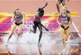  ?? FRANK AUGSTEIN/ASSOCIATED PRESS ?? Emma Coburn, right, and Courtney Frerichs, left, pass Kenya’s Hyvin Kiyeng Jepkemoi in the women’s steeplecha­se final Friday.