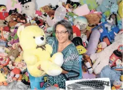  ??  ?? BEARING UP: Patricia de Lille with donated toys destined for libraries and early developmen­t centres across Cape Town.