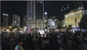  ?? THE ASSOCIATED PRESS ?? Protesters stand in unity in Romare Bearden Park as they prepare to march throughout the city of Charlotte, N.C., on Friday.