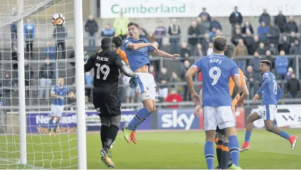  ??  ?? Richie Bennett heads Carlisle United’s opener in their 3-2 victory against Oldham. PICTURE: MARK FULLER