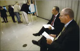  ?? JIM MONE — THE ASSOCIATED PRESS FILE ?? On Nov. 2, 2004, parliament­arians Goran Lennmarker, right, of Sweden and Stavros Evagorow, of Cyprus, observe the American voting process as voters cast their ballots at Robbinsdal­e City Hall in Robbinsdal­e, Minn. The two men are members of the Organizati­on for Security and Cooperatio­n in Europe.