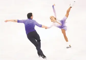  ?? Richard Heathcote / Getty Images ?? Aliona Savchenko and Bruno Massot of Germany scored 235.90 points, lifting them from fourth place after a shaky short program to Germany’s first pairs gold since 1952.