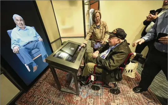  ?? PHOTOS BY GERALD HERBERT/AP ?? World War II veteran Olin Pickens, 102, who served in a U.S. Army tank destroyer battalion, looks at the virtual exhibit of himself at the National World War II Museum. A new interactiv­e exhibit will use artificial intelligen­ce to let visitors hold virtual conversati­ons with images of veterans, including a Medal of Honor winner who died in 2022.