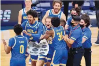  ?? AJ MAST/ASSOCIATED PRESS ?? UCLA players celebrate after beating Alabama 88-78 in overtime of a Sweet 16 game on Sunday. UCLA will play against Michigan on Tuesday night.