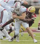  ?? STAFF PHOTO BY STUART CAHILL ?? TAKEDOWN: UMass quarterbac­k Ross Comis is sacked by BC’s Lukas Denis, one of six by the Eagles.