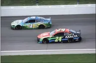  ?? Sean Gardner / Getty Images ?? Kevin Harvick, driver of the No. 4 Busch Light For The Farmers Ford, and William Byron race during the NASCAR Cup Series Buschy McBusch Race 400 at Kansas Speedway on May 2 in Kansas City, Kan.