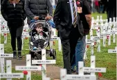  ??  ?? Two-year-old Ariki Ngawhika gets an early introducti­on to the casualties of war.