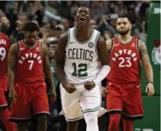  ?? WINSLOW TOWNSON/THE ASSOCIATED PRESS ?? Terry Rozier, who delivered 16 points off the Celtics bench, leads the celebratio­n after holding off Kyle Lowry, Fred VanVleet and the Raptors.