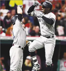  ?? DAVID DERMER — THE ASSOCIATED PRESS ?? The Yankees’ Didi Gregorius, right, is congratula­ted by Brett Gardner after Gregorius hit a two-run home run off Indians starting pitcher Corey Kluber during Game 5’s third inning.