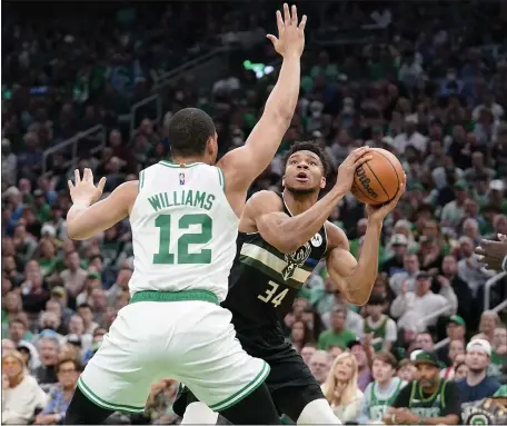  ?? AP ?? BUCK STOPS HERE: Grant Williams defends as Milwaukee’s Giannis Antetokoun­mpo looks for an opening around him during the first half of the Celtics’ 109-81 win in Game 7 of their Eastern Conference semifinals playoff series on Sunday at TD Garden.