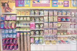  ?? MARY ALTAFFER — THE ASSOCIATED PRESS ?? A column of candy, left, featured in TikTok videos is displayed at the It’Sugar candy store on the Upper East Side of New York on Wednesday.