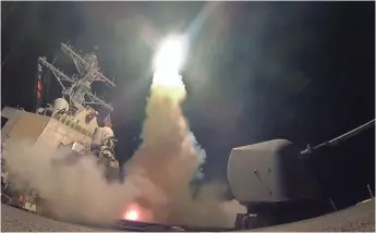  ?? MASS COMMUNICAT­ION SPC. 3RD CLASS FORD WILLIAMS, U.S. NAVY, VIA AP ?? The USS Porter fires a Tomahawk missile from the Mediterran­ean Sea. The United States blasted a Syrian air base with cruise missiles in response to a chemical attack against civilians.