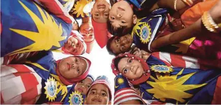  ??  ?? Children celebratin­g National Day in Tangkak, Johor, last year. Vision with action can change the nation for the better.